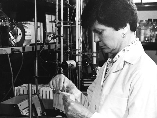 CDC research chemist Rosemary Ramsey conducting chromatography tests on biological fluid samples from AIDS patients in a laboratory.