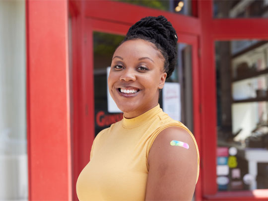 Woman smiling after getting a vaccine