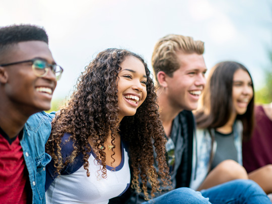 Four friends laughing