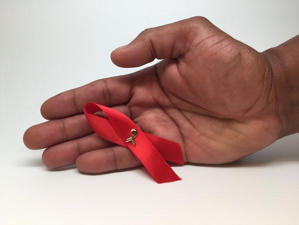 Hand holding a AIDS ribbon